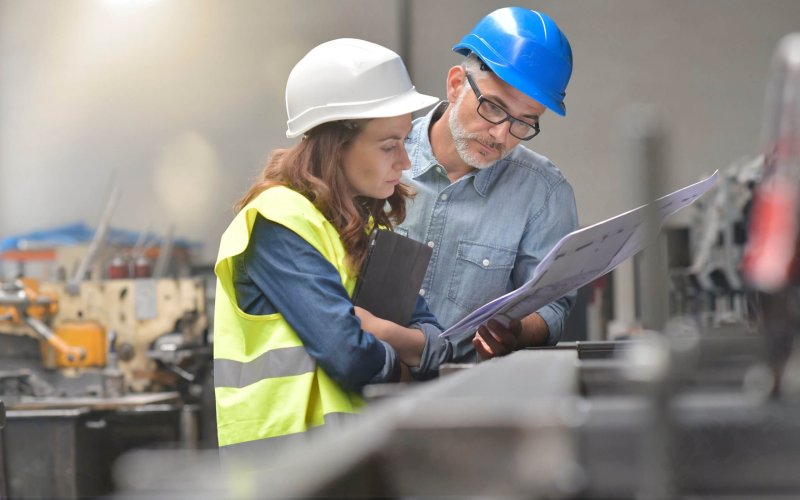 Metal industry manager and engineer meeting in factory